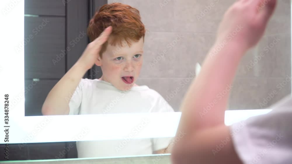Funny red-haired boy dancing in the bathroom. Personal hygiene Funny red-haired boy dancing in the bathroom. Personal hygiene