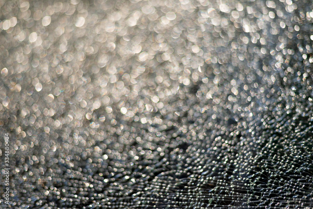Broken glass texture with shiny bokeh background, selective focus Broken glass texture with shiny bokeh background, selective focus