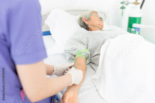 healthcare worker use syringe and needle drawing blood of old asian patient  blood drawing process  laboratory confirm to diagnosis  old patient in hospital