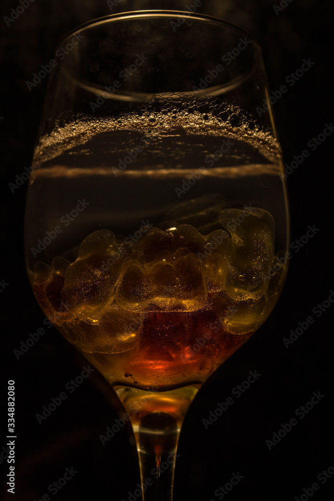 Unusual bright cocktail. Cocktail in a glass. The sun in the glass. Fire cocktail. Background. Unusual bright cocktail. Cocktail in a glass. The sun in the glass. Fire cocktail. Background.