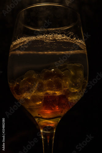 Unusual bright cocktail. Cocktail in a glass. The sun in the glass. Fire cocktail. Background.