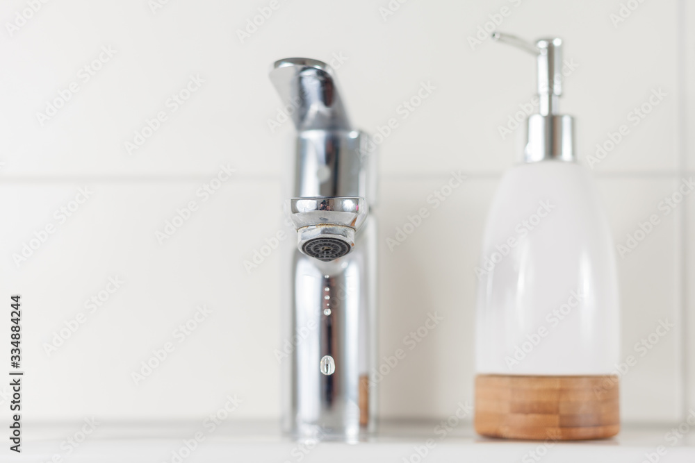 Sink with soap dispenser in bathroom. Corona virus hygiene concept. Sink with soap dispenser in bathroom. Corona virus hygiene concept.