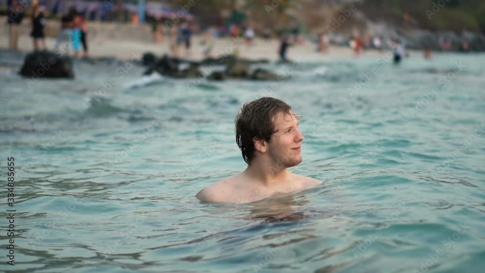 Smiling Man Floating in Crystal Clear Water of Tropical Island Smiling Man Floating in Crystal Clear Water of Tropical Island