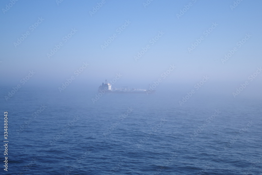 Ship sailing in fog at sea