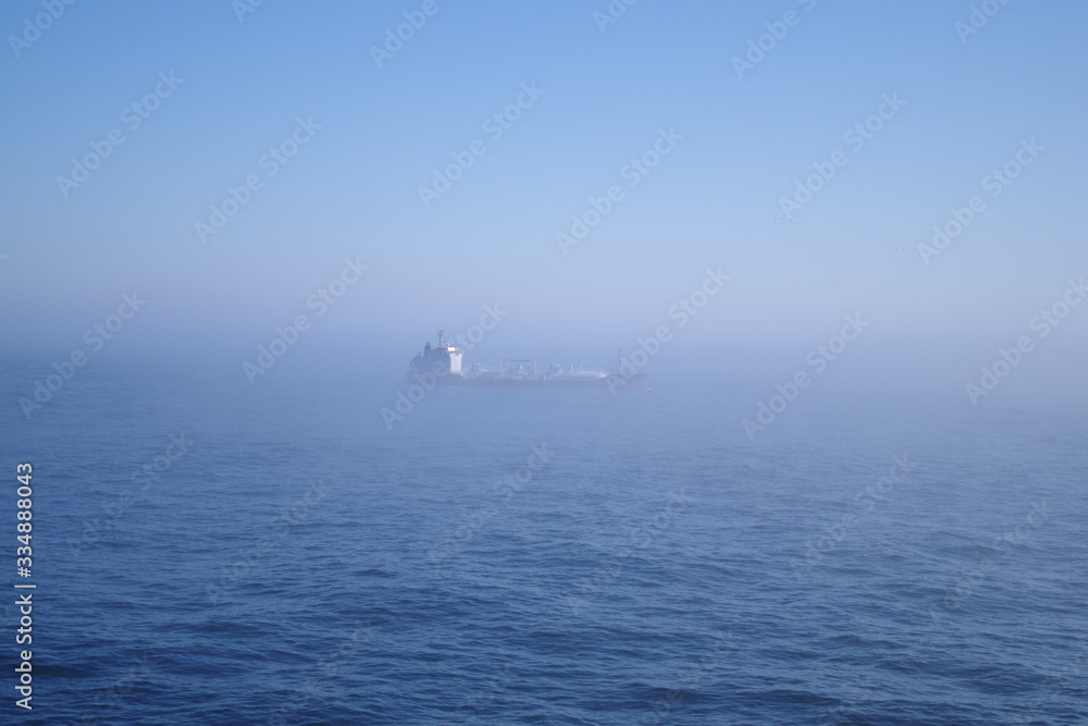 Ship sailing in fog at sea Ship sailing in fog at sea