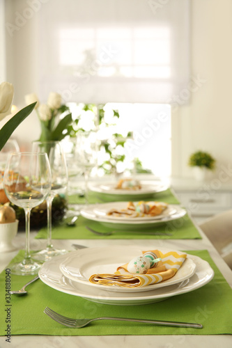 Festive Easter table setting with floral decor in kitchen