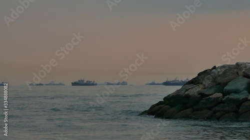Wallpaper Mural Long shot of oil tankers and cargo ships in the conflict area of Hormuz strait in Persian Gulf Iran at dusk Torontodigital.ca