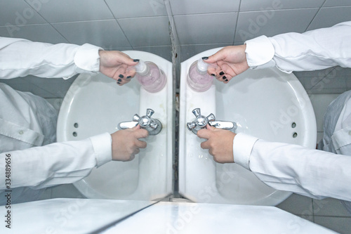 double washing of woman's hands in a bathroom taken from above 7