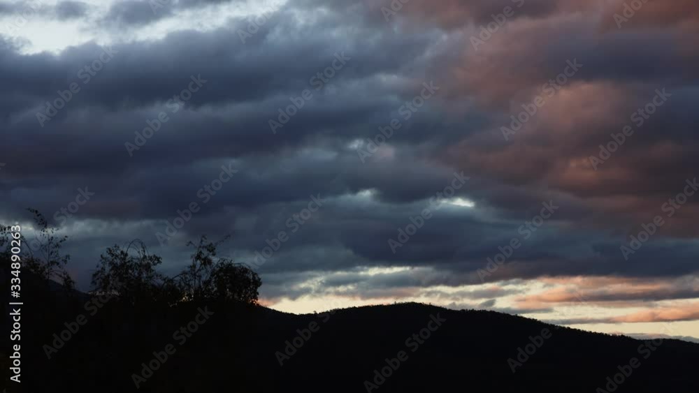 timelapse of sunset clouds passing by and weather changing at dusk over the mountains, shot in Tasmania over Mount Wellington timelapse of sunset clouds passing by and weather changing at dusk over the mountains, shot in Tasmania over Mount Wellington