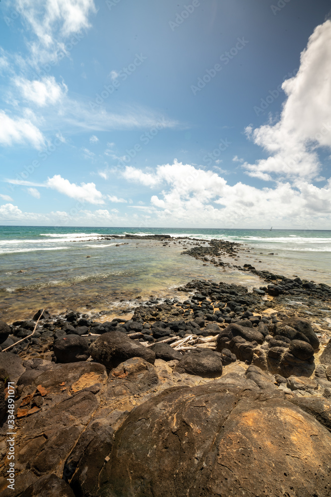 Hawaii Coastline with a view of the sea and rocks during sunny summer weather