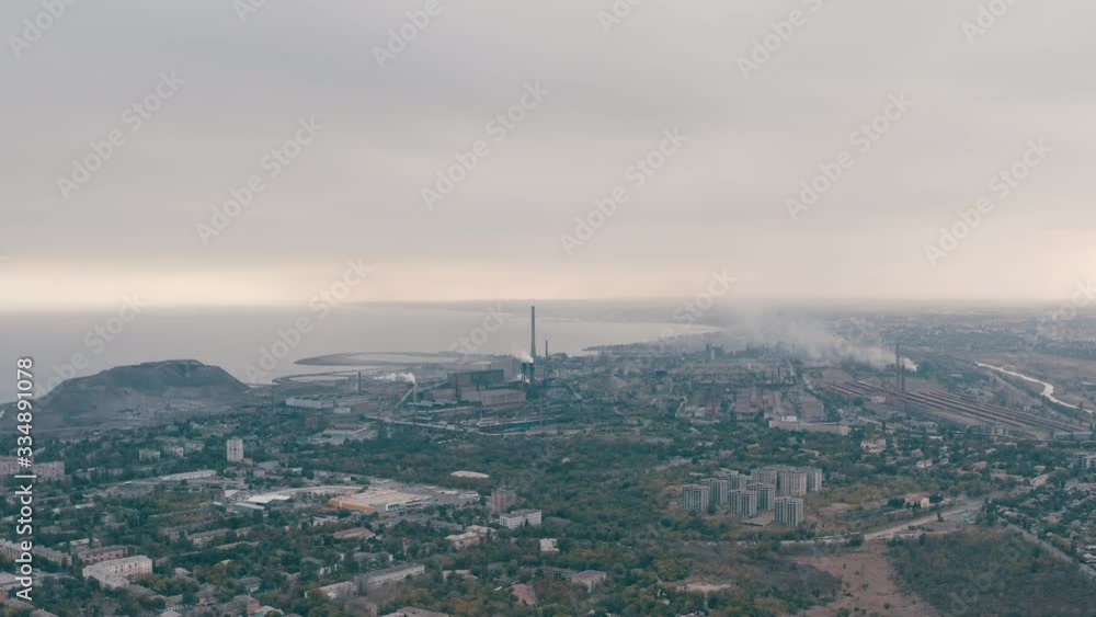 Industrial city in summer. On the horizon, a metallurgical plant near the sea. Aerial view. Mariupol, Ukraine Industrial city in summer. On the horizon, a metallurgical plant near the sea. Aerial view. Mariupol, Ukraine