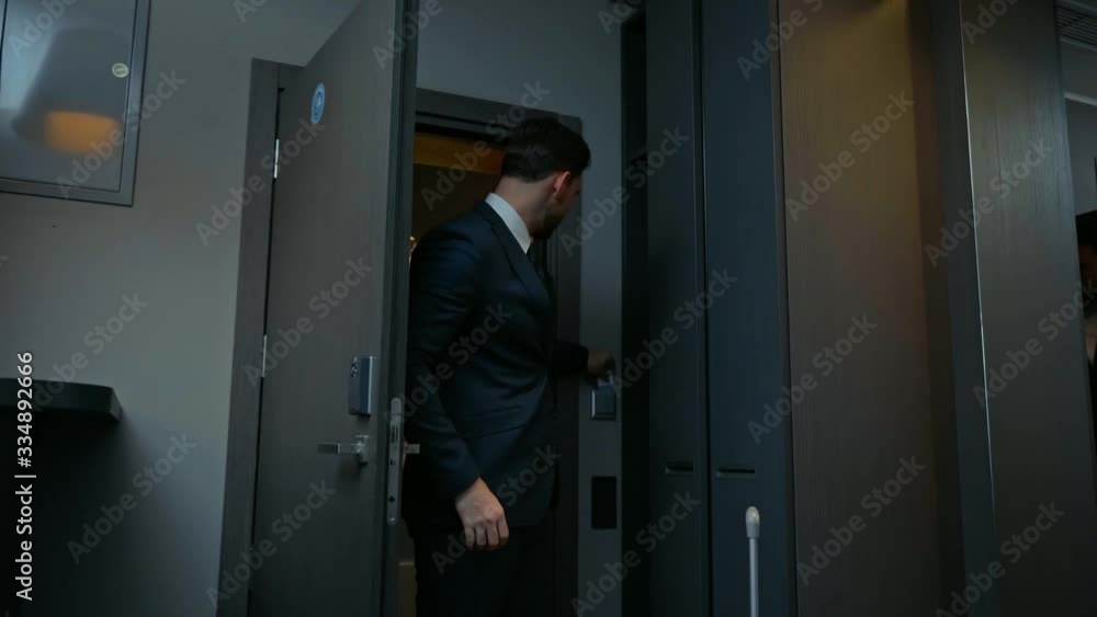 handsome businessman entering hotel room handsome businessman entering hotel room