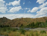 Scenic roadside view of Wyoming landscape with the Soshone River along the North Fork Highway.