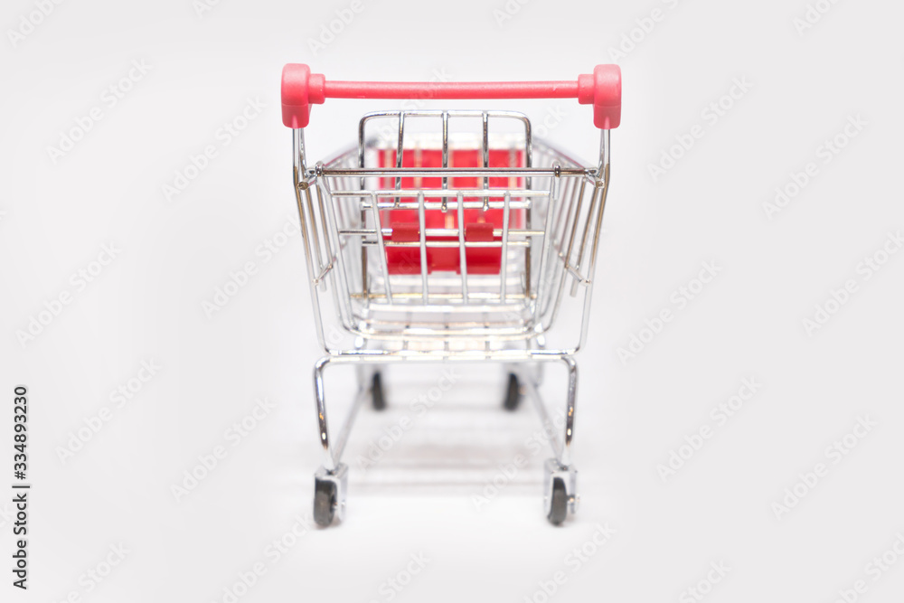 Shopping trolley or supermarket cart with isolated white background. Business shopping concept. Selected focus and close up object.