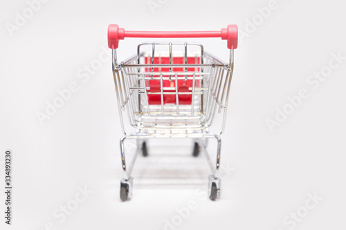 Shopping trolley or supermarket cart with isolated white background. Business shopping concept. Selected focus and close up object. © Nattawit