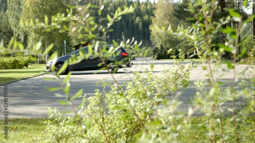 A car arriving at a cemetery in Sweden on a sunny day photo