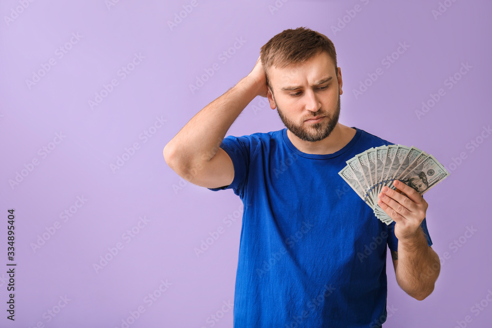 Handsome thoughtful man with money on color background Handsome thoughtful man with money on color background