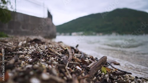 Wallpaper Mural Slow-motion rack focus of waves crashing against the lakeshore with scattered sticks and pebbles using a shallow depth of field during the fall. Location: Lake Traunsee Gmunden Austria near Hallstatt. Torontodigital.ca