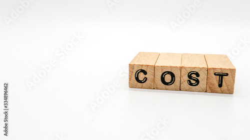 Wooden Text Block of "COST" on Isolated Background