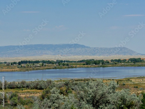 Lake along North Fork Highway in Wyoming, with a village in the distance.