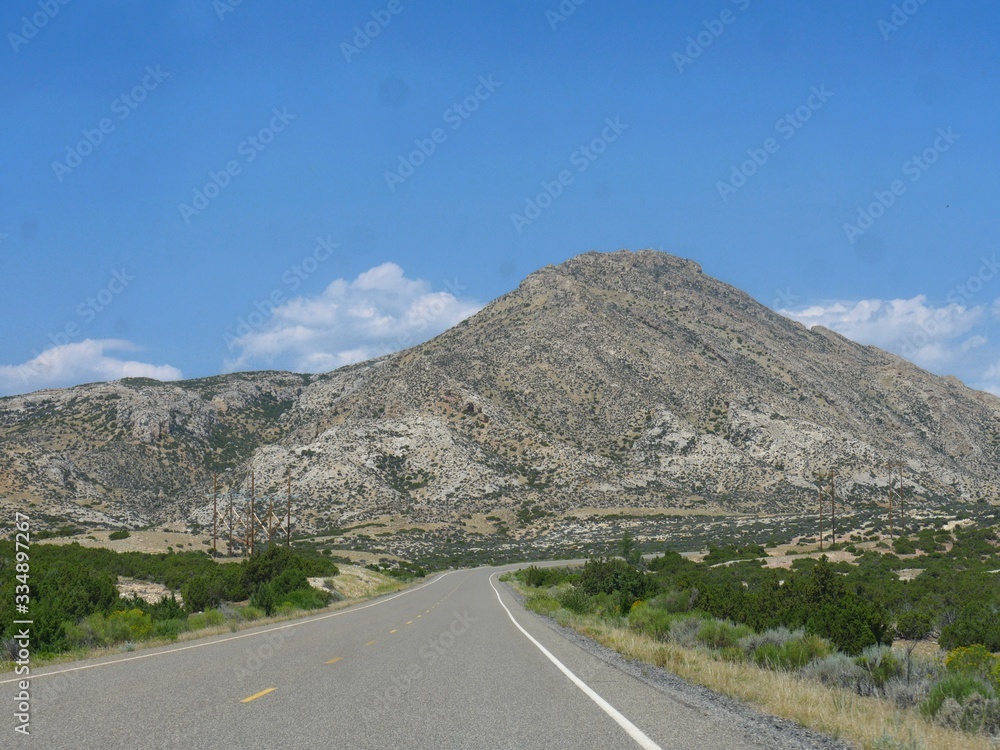 Scenic landscape witha bare rock mountain along the road at the Wyoming-Montana border.