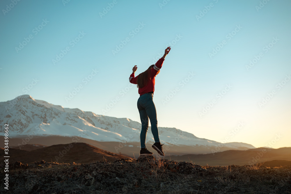 Slim girl traveler walks in mountains Slim girl traveler walks in mountains