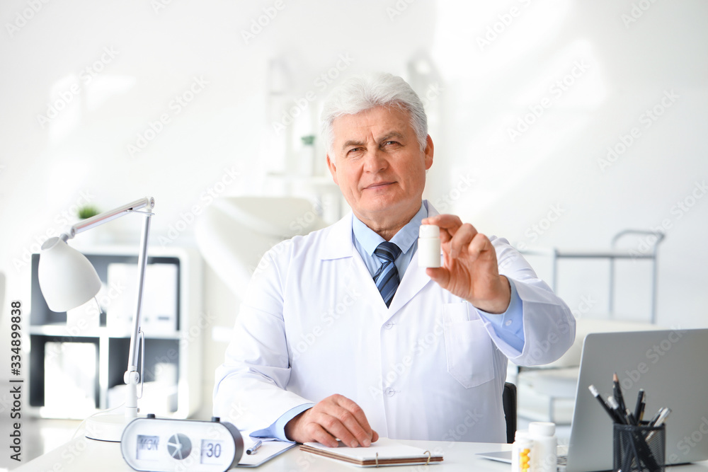 Senior doctor with pills in clinic Senior doctor with pills in clinic