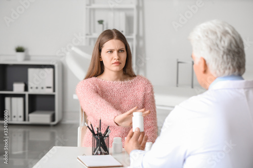 Young woman refusing to tak...