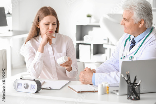 Doctor giving pills to pati...
