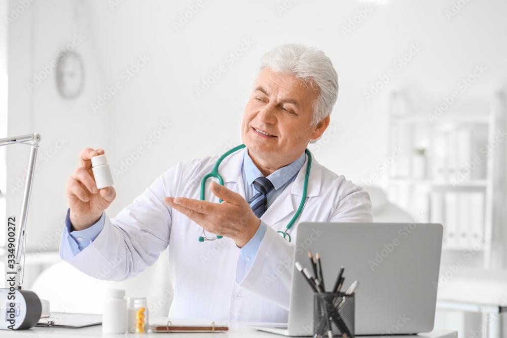 Senior doctor with pills in clinic Senior doctor with pills in clinic