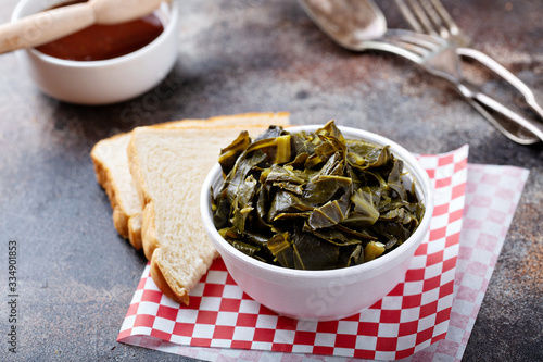 Cooked collard greens in a foam bowl, southern barbeque side photo