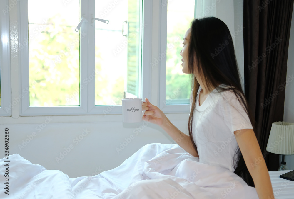 woman drink a cup of coffee in bedroom woman drink a cup of coffee in bedroom