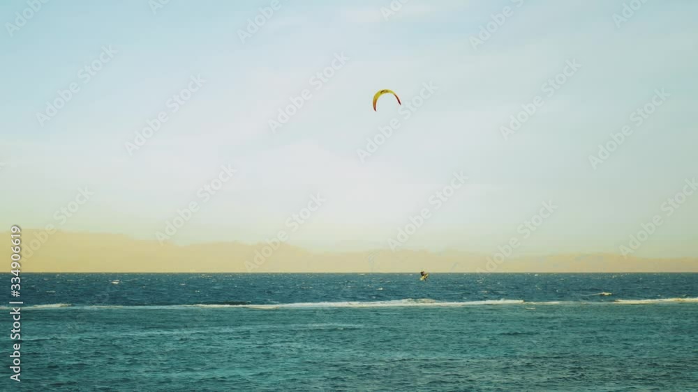 Kite surfing in beautiful clear water in Dahab Egypt. Exploring the blue water with mountains in the background and people windsurfing and kite surfing, slow motion, 4k Kite surfing in beautiful clear water in Dahab Egypt. Exploring the blue water with mountains in the background and people windsurfing and kite surfing, slow motion, 4k