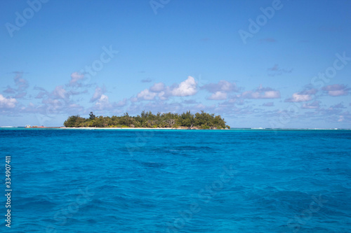 Landscape photo of Managaha Island, an uninhabited island in Saipan, USA, with blue sea and blue sky. photo