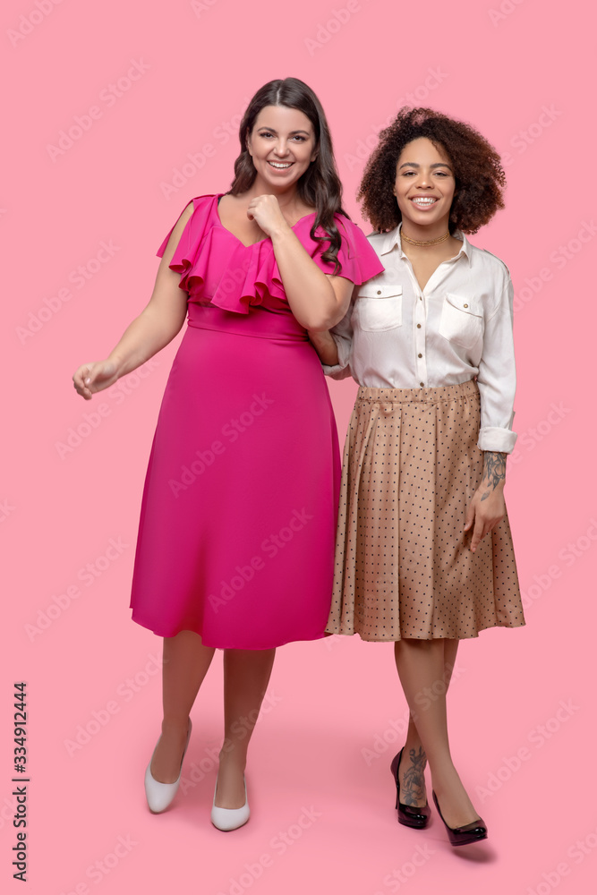 Two young women in elegant clothes and shoes. Two young women in elegant clothes and shoes.