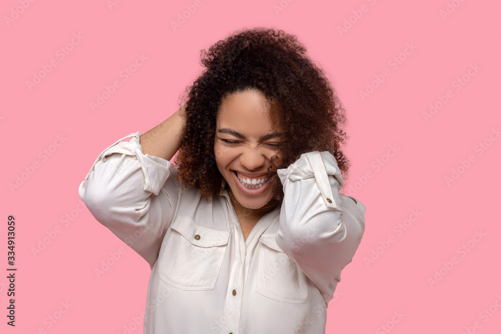 Laughing woman with eyes closed hands behind her head. Laughing woman with eyes closed hands behind her head.