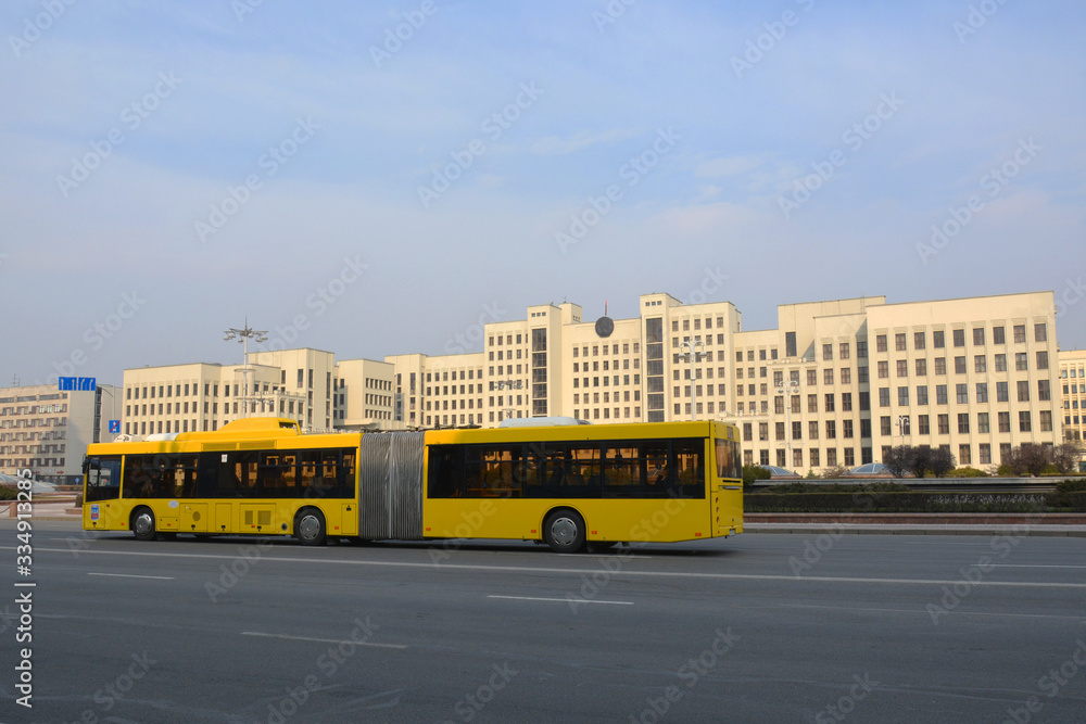 MINSK, BELARUS - MARCH 29 2020 :The House of the Government of the Republic of Belarus and  yellow bus