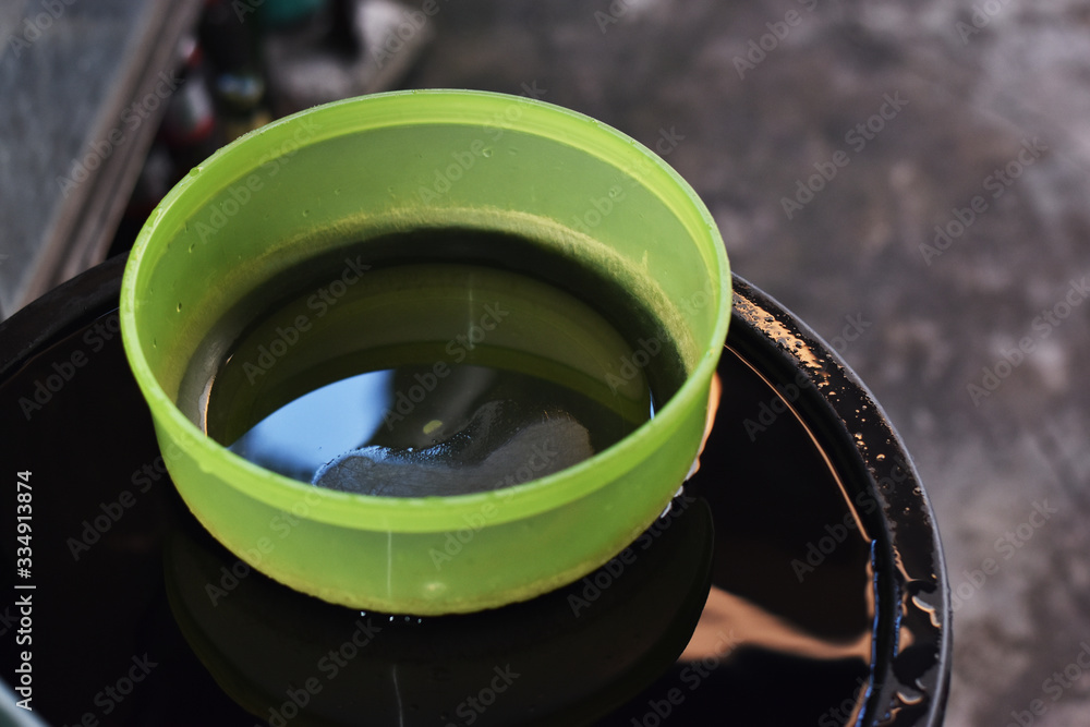 a green bowl floating on a water tank a green bowl floating on a water tank