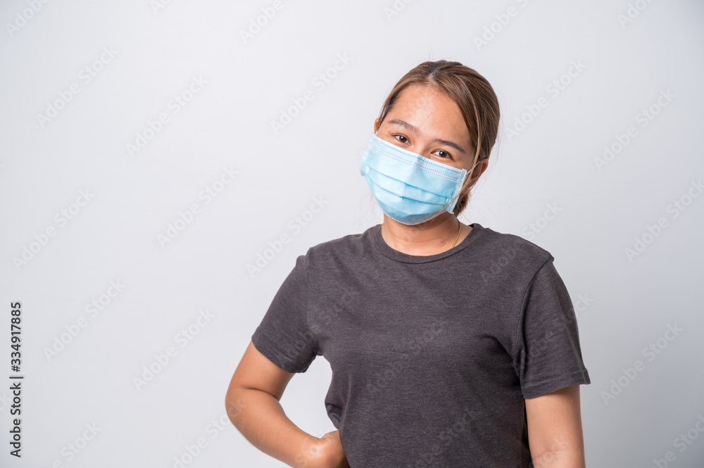 Covid-19 Concept,Asian young woman wearing a hygiene protective mask over her face on White background,Coronavirus Covid-19 and Air pollution pm2.5 concept background. Covid-19 Concept,Asian young woman wearing a hygiene protective mask over her face on White background,Coronavirus Covid-19 and Air pollution pm2.5 concept background.