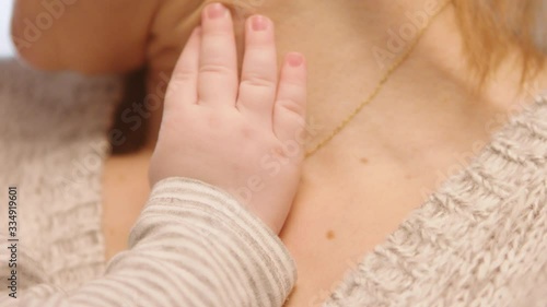 Wallpaper Mural Close up shot of tiny baby hand touching the mothers neck. slow motion shot Torontodigital.ca
