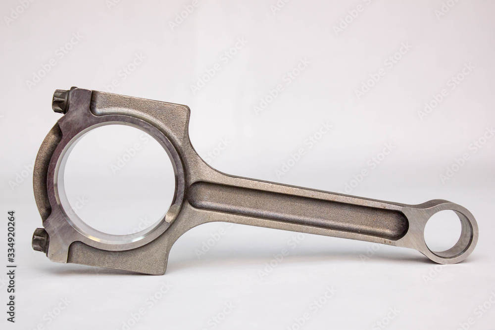 Connecting rod from a car engine isolated on white. Connecting rod from a car engine isolated on white.