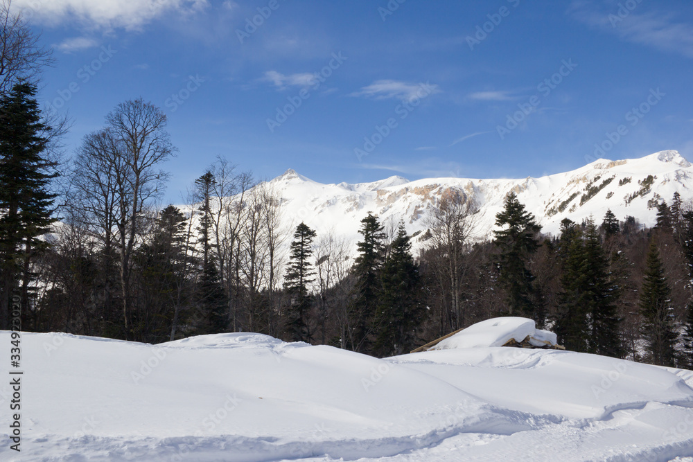 Beautiful mountains covered with snow. Sunny day and blue sky on a frosty day