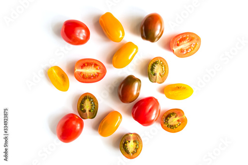 various colorful tomatoes isolated on white background. Top view, flat lay. Creative layout