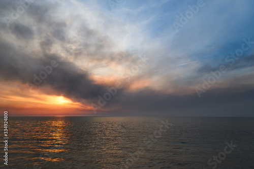 Sea sunset. Smoke wildfires sweeping across the sky. © PhotoBetulo