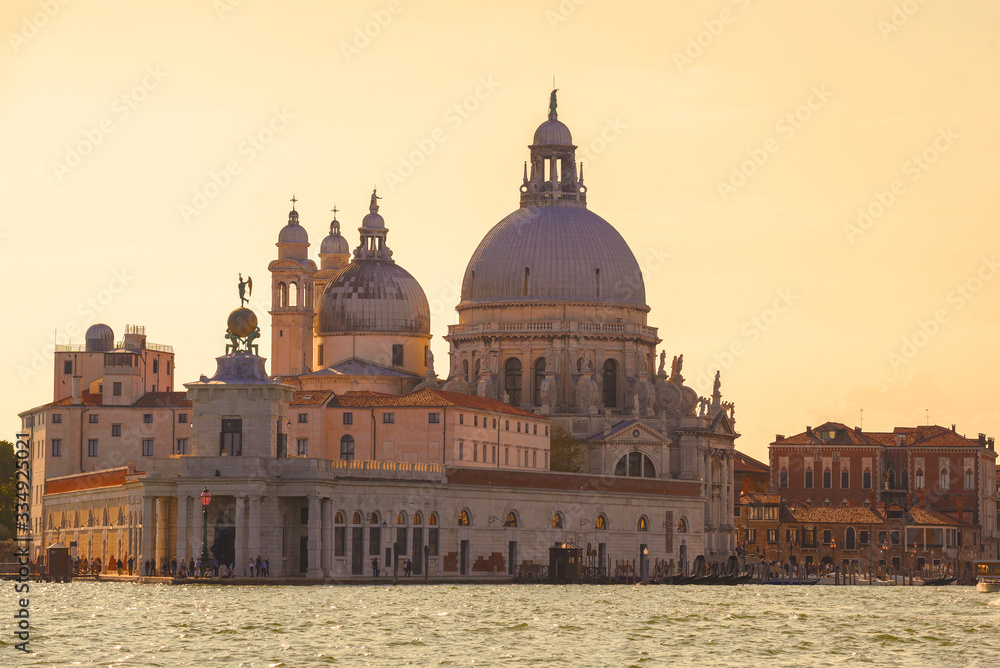 Basilica di Santa Maria della Salute and the ancient customs building of Punta della Dogana on a sunny September evening. Venice, Italy