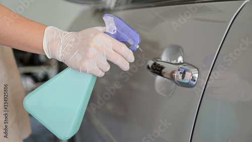 Cropped shot of Spray to clean and disinfect the handle to open the car door.