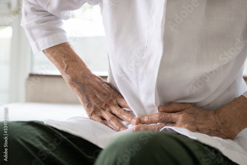 Billede på lærred Sick senior patient having aching belly,hands hold stomach,stomachache,old peopl