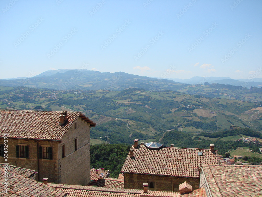 Mountain panorama of the neighborhood of San Marino on a background of blue sky in a clear sunny day.