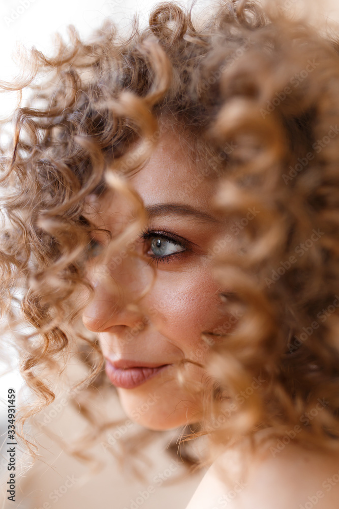 Large portrait of a happy cheerful beautiful cheerful cute bright curly teenage girl with clear skin and a beautiful smile, self-care self-love, beauty shooting Large portrait of a happy cheerful beautiful cheerful cute bright curly teenage girl with clear skin and a beautiful smile, self-care self-love, beauty shooting