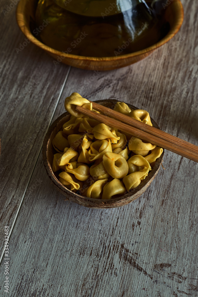 Fototapeta premium Bowl with ravioli and chopsticks